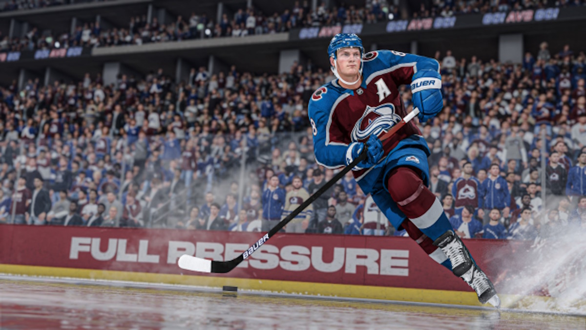 A Colorado Avalanche player is skating down the ice, aiming a puck shot.